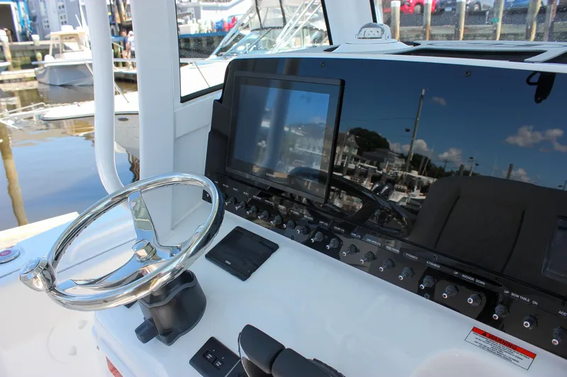 Slide: The Image of Steering console of 2027 Sea Hunt Ultra 265SE boat with modern controls and display. - 29