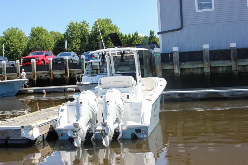 Slide: The Image of Sea Hunt Ultra 265SE 2027 boat docked at marina with twin engines. - 1