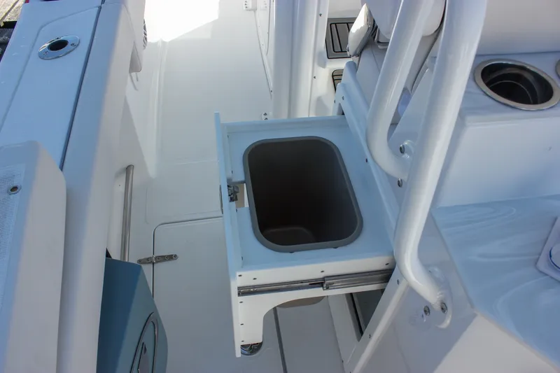 Slide: The Image of 2027 Sea Hunt Ultra 265SE boat interior with open storage compartment. - 44
