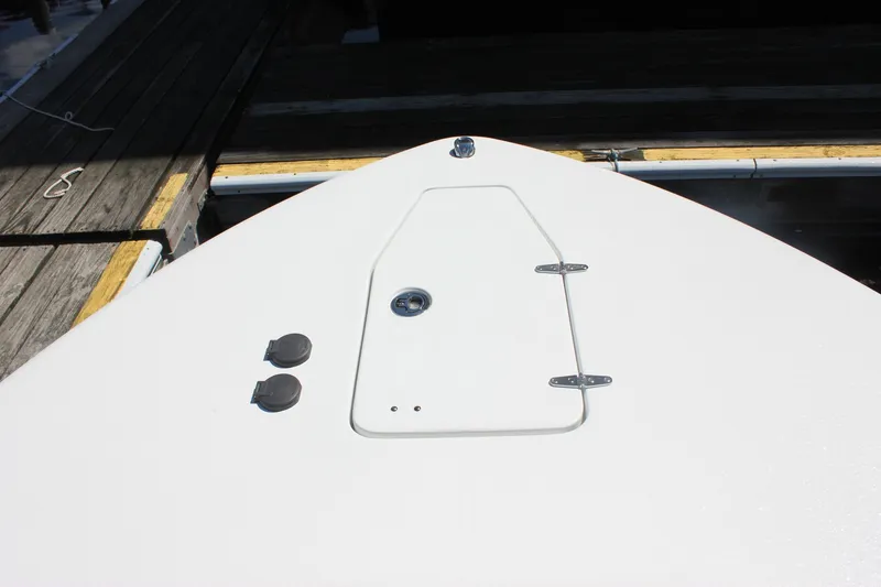 Slide: The Image of Bow of 2027 Sea Hunt Ultra 265SE boat at dock, featuring hatch and fittings. - 40