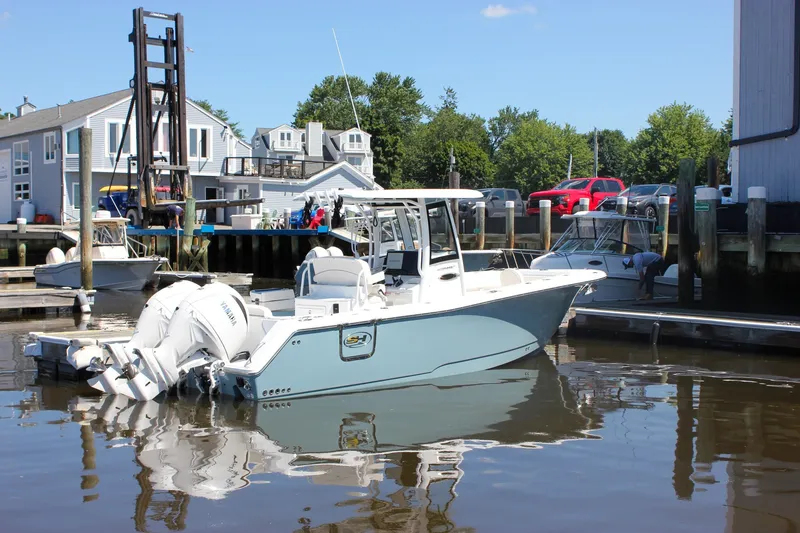 The Image of 2027 Sea Hunt Ultra 265SE boat docked at a marina with dual Yamaha engines. - 0