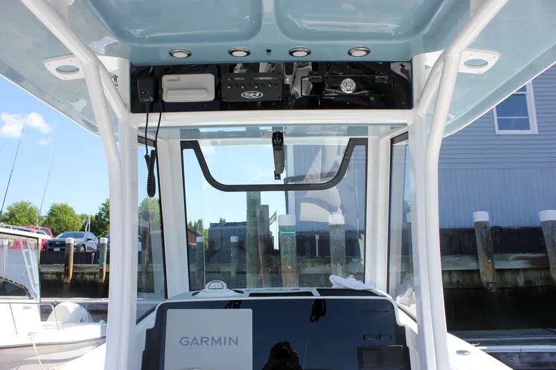 Slide: The Image of 2027 Sea Hunt Ultra 265SE boat console with Garmin electronics and overhead storage. - 20