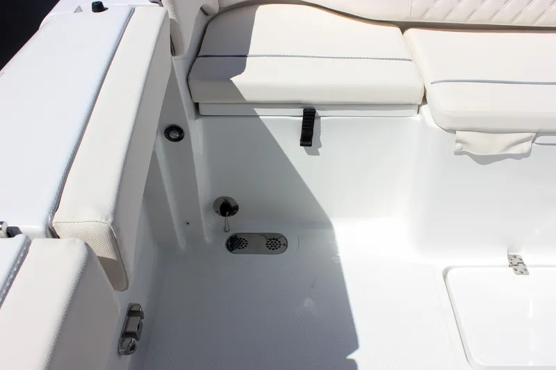 Slide: The Image of Interior seating area of 2027 Sea Hunt Ultra 265SE boat, featuring white cushioned seats. - 7