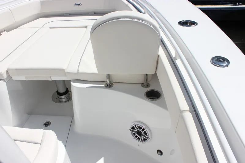 Slide: The Image of Interior view of 2027 Sea Hunt Ultra 265SE boat, featuring white seating and speaker. - 37