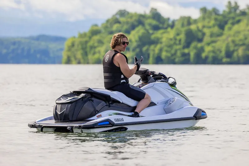 Slide: The Image of Manufacturer Provided Image: Man riding 2026 Yamaha WaveRunner VX Deluxe on a scenic lake. - 6