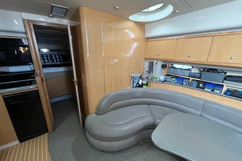 Slide: The Image of Luxurious interior of 2004 Maxum 4200 SY yacht with modern seating and storage. - 8