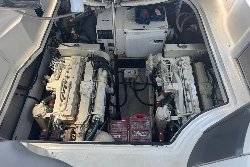 Slide: The Image of Engine compartment of 2004 Maxum 4200 SY yacht, featuring dual engines and marine generator. - 14