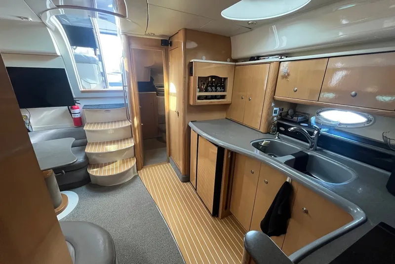 Slide: The Image of Luxurious 2004 Maxum 4200 SY yacht interior with modern kitchen and seating area. - 6