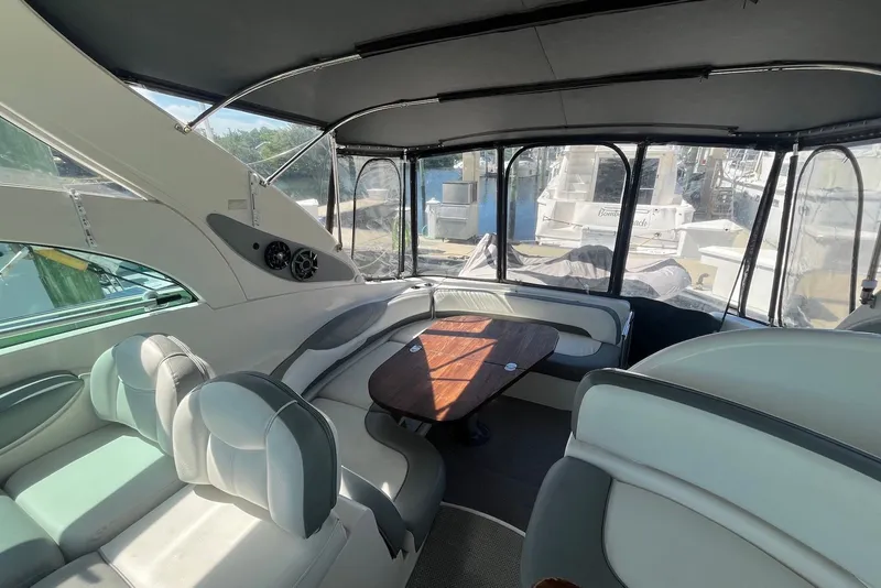 Slide: The Image of Luxurious interior of 2004 Maxum 4200 SY yacht with seating and wooden table. - 2