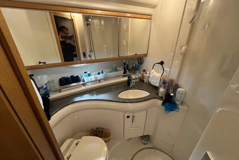 Slide: The Image of Bathroom interior of 2004 Maxum 4200 SY yacht, featuring sink and toiletries. - 13