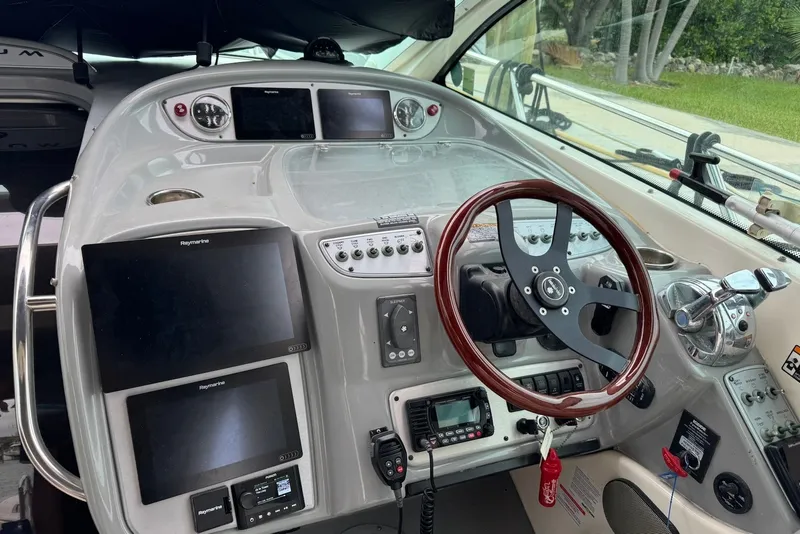 Slide: The Image of Cockpit of 2004 Maxum 4200 SY yacht with advanced navigation systems and controls. - 4