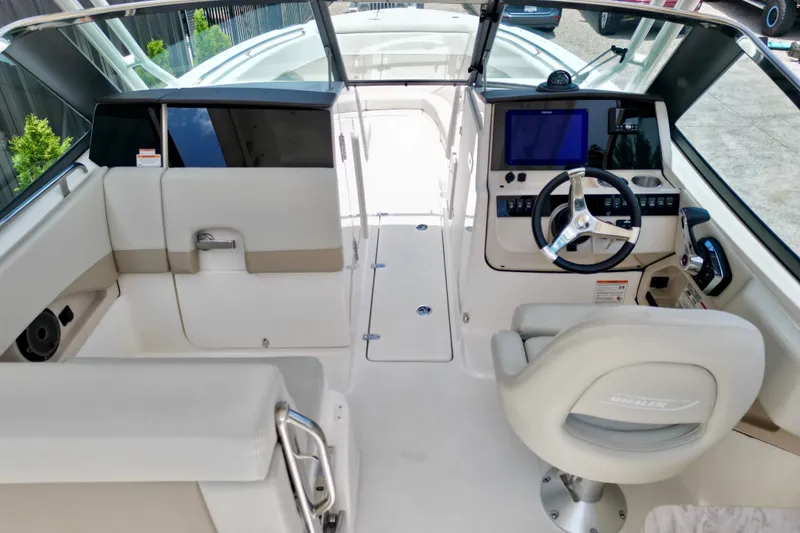Slide: The Image of 2025 Boston Whaler 240 Vantage boat interior with modern helm and seating. - 10