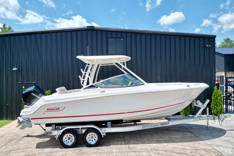 The Image of 2025 Boston Whaler 240 Vantage boat on trailer, parked outdoors. - 0