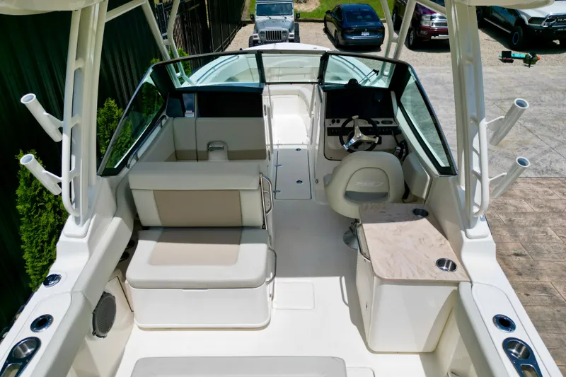 Slide: The Image of 2025 Boston Whaler 240 Vantage boat interior with seating and steering console. - 11