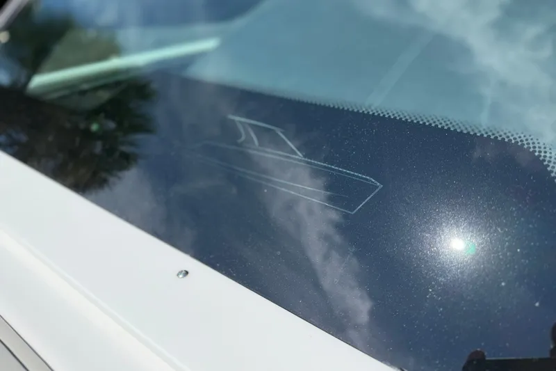 Slide: The Image of Windshield of 2027 Monterey Elite 27 OB boat reflecting sunlight and sky. - 14