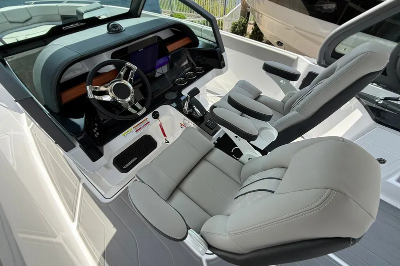 Slide: The Image of Luxurious cockpit of 2027 Monterey Elite 27 OB boat with modern steering and seating. - 19