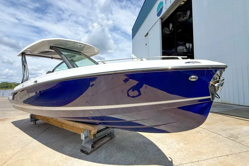 The Image of 2027 Monterey Elite 27 OB boat with sleek blue hull, docked outdoors. - 0