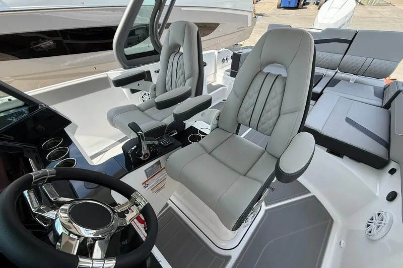 Slide: The Image of Luxurious interior of 2027 Monterey Elite 27 OB boat with plush seating and modern controls. - 17