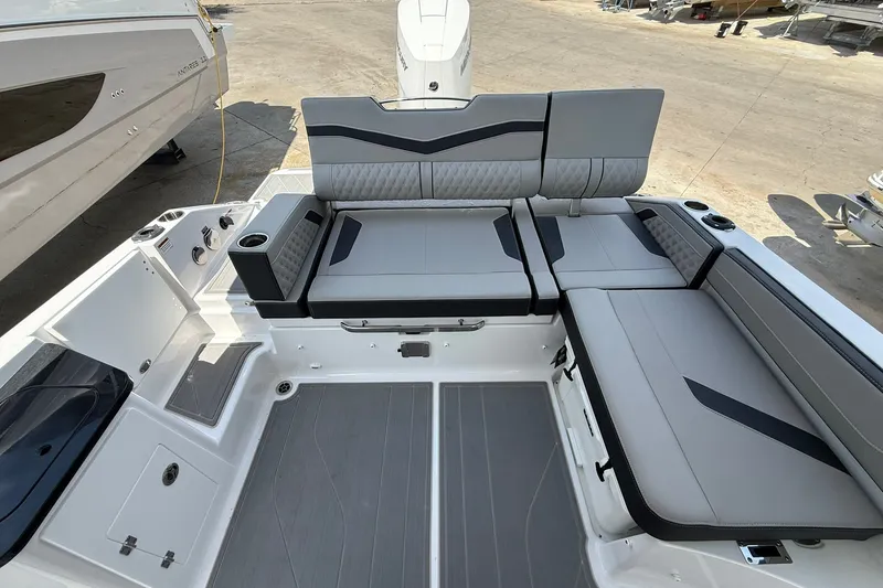 Slide: The Image of Spacious seating area on a 2027 Monterey Elite 27 OB boat, featuring modern gray upholstery. - 22