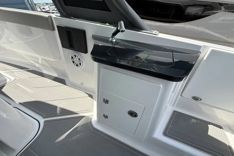Slide: The Image of Interior of 2027 Monterey Elite 27 OB boat featuring sleek sink and storage area. - 21