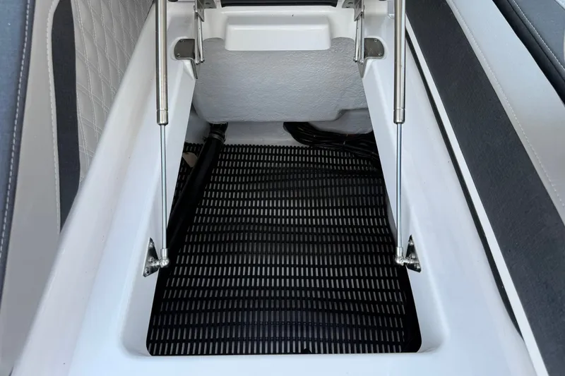 Slide: The Image of Storage compartment of 2027 Monterey Elite 27 OB boat with hydraulic supports. - 24
