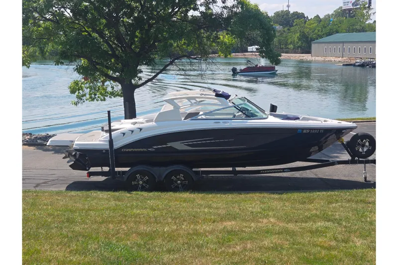 The Image of 2022 Chaparral 23 SSi boat on trailer by a scenic lakeside. - 0