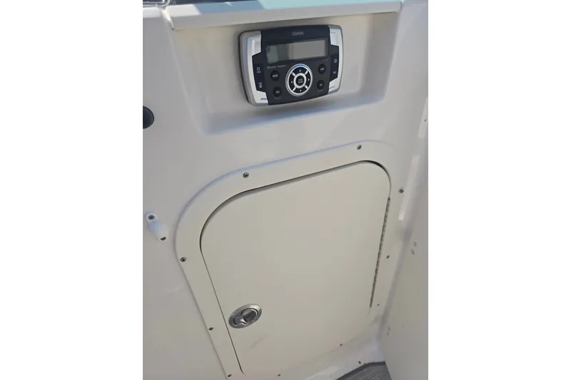 Slide: The Image of 2022 Chaparral 23 SSi boat interior with control panel and storage compartment. - 15
