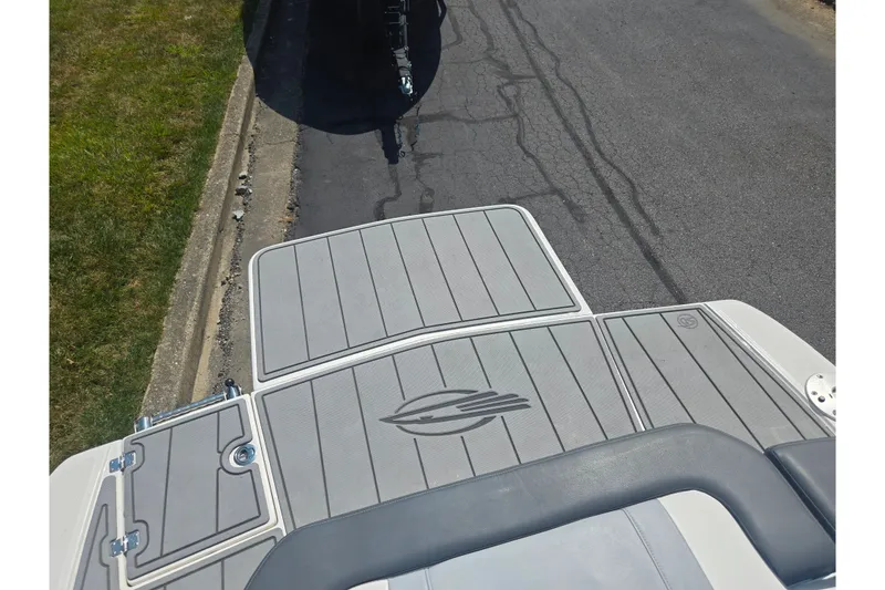 Slide: The Image of 2022 Chaparral 23 SSi boat deck with sleek gray design and logo detailing. - 26
