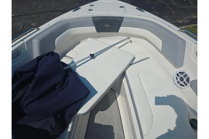 Slide: The Image of 2022 Chaparral 23 SSi boat interior with seating and table setup. - 18