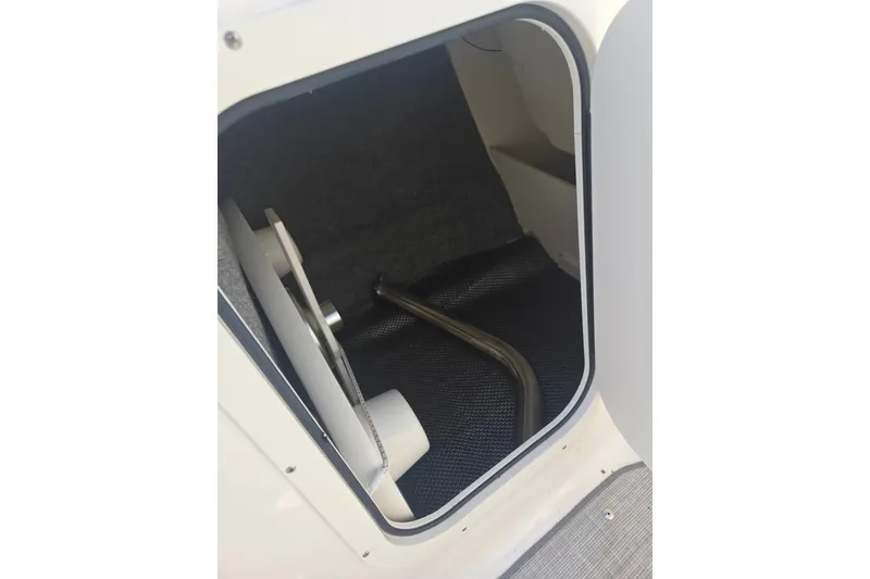 Slide: The Image of Storage compartment inside 2022 Chaparral 23 SSi boat, featuring a sleek interior design. - 16