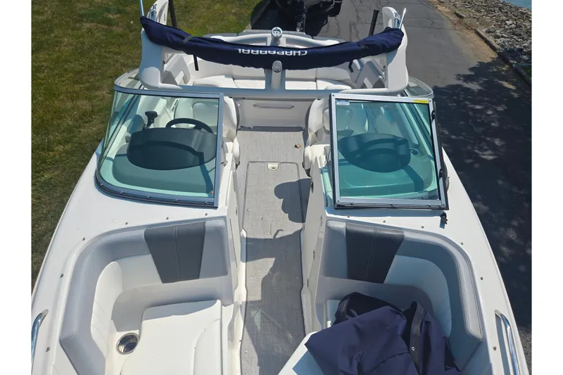 Slide: The Image of 2022 Chaparral 23 SSi boat interior with open windshield and seating area. - 21