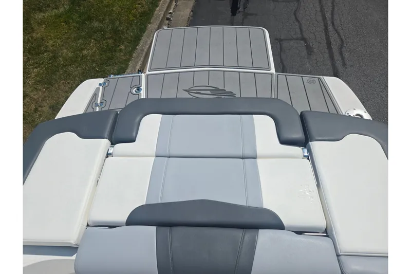 Slide: The Image of 2022 Chaparral 23 SSi boat with gray and white seating and swim platform. - 24