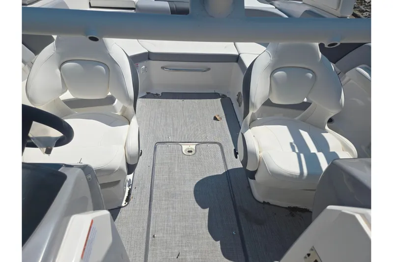 Slide: The Image of 2022 Chaparral 23 SSi boat interior with white seating and gray flooring. - 22