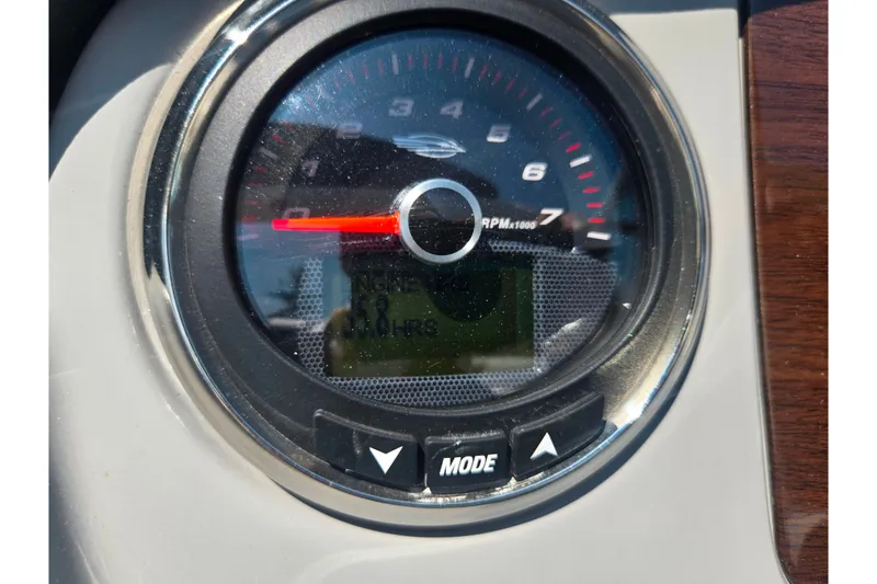 Slide: The Image of Close-up of 2022 Chaparral 23 SSi tachometer displaying RPM and mode buttons. - 27