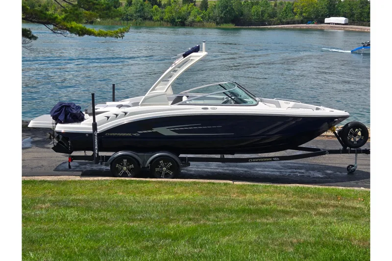 The Image of 2022 Chaparral 23 SSi boat on trailer by a scenic waterfront. - 0