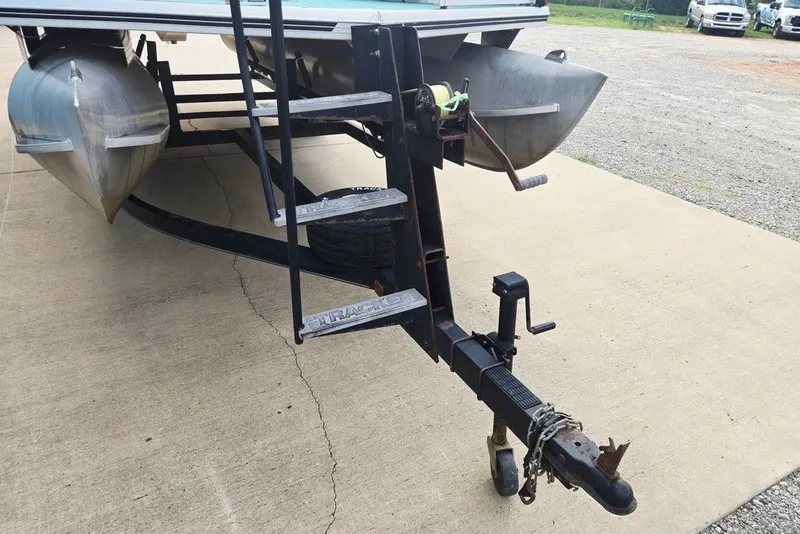 Slide: The Image of 1998 Sun Tracker Fishin' Barge 21 Signature Series on trailer, showing front steps and hitch. - 18