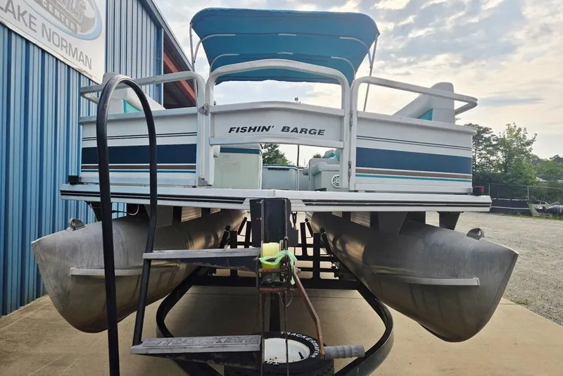 Slide: The Image of 1998 Sun Tracker Fishin' Barge 21 Signature Series pontoon boat on trailer. - 19