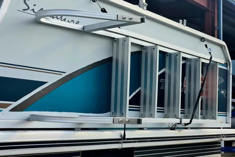 Slide: The Image of 1998 Sun Tracker Fishin' Barge 21 Signature Series boat ladder and side view. - 17
