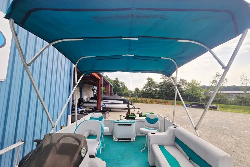 Slide: The Image of 1998 Sun Tracker Fishin' Barge 21 Signature Series with blue canopy and seating. - 24