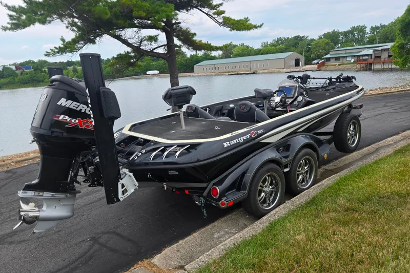 Slide: The Image of 2016 Ranger Z521 Comanche boat with Mercury Pro XS engine by a lakeside. - 1