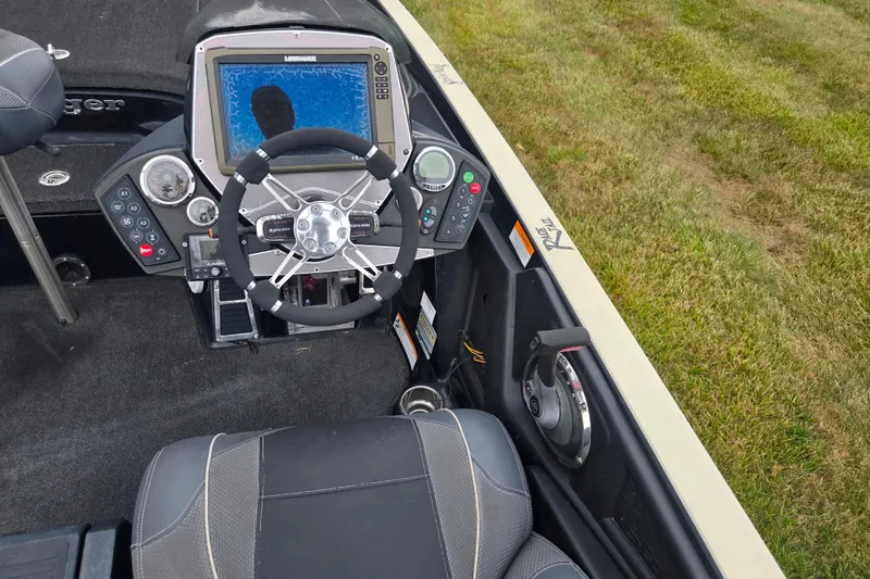 Slide: The Image of 2016 Ranger Z521 Comanche boat cockpit with steering wheel and control panel. - 12