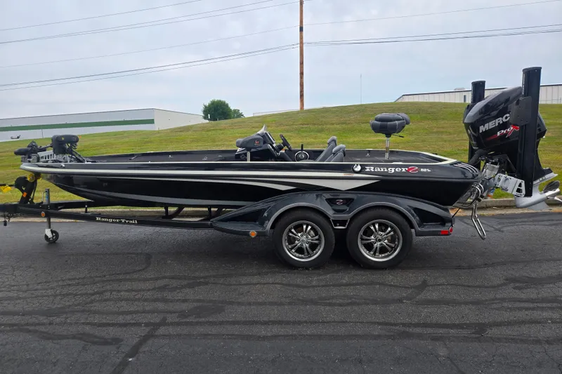Slide: The Image of 2016 Ranger Z521 Comanche boat on trailer, black with white accents, parked outdoors. - 4