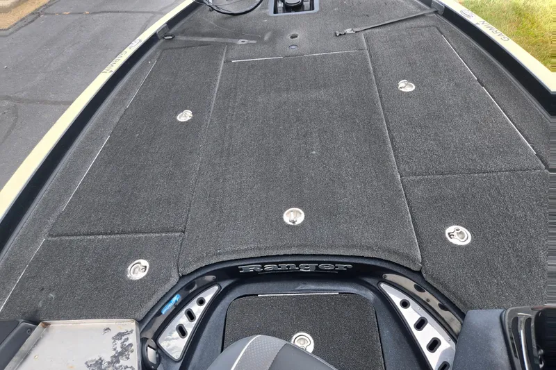 Slide: The Image of 2016 Ranger Z521 Comanche boat deck with carpeted surface and storage compartments. - 14