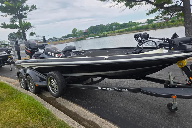 Slide: The Image of 2016 Ranger Z521 Comanche boat on trailer by a lakeside road. - 9