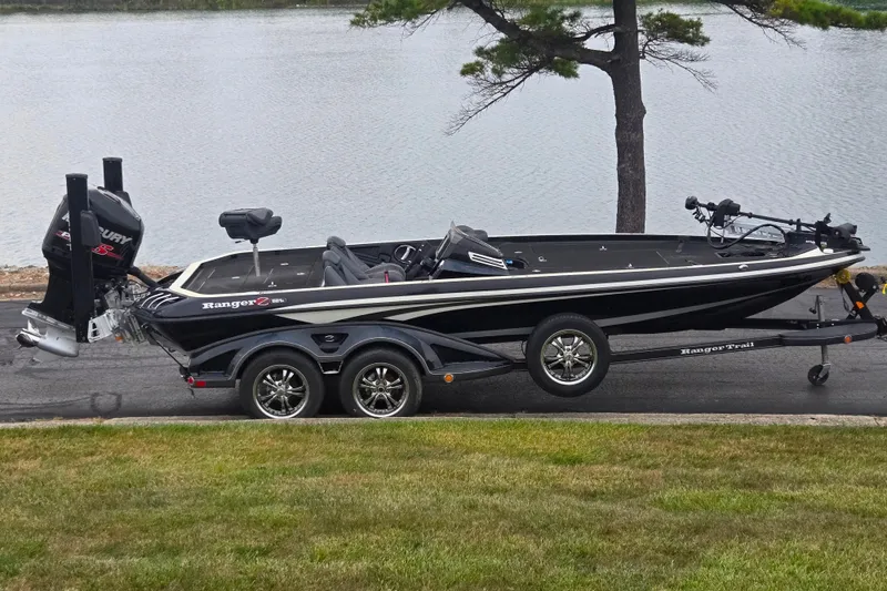 The Image of 2016 Ranger Z521 Comanche boat on trailer by a lake. - 0