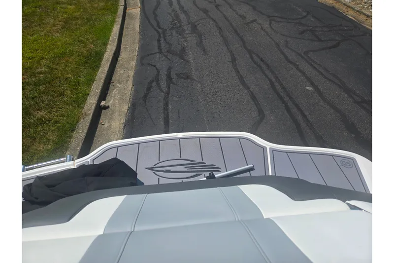 Slide: The Image of 2023 Chaparral 21 SSi boat on a paved road, rear view with logo visible. - 28