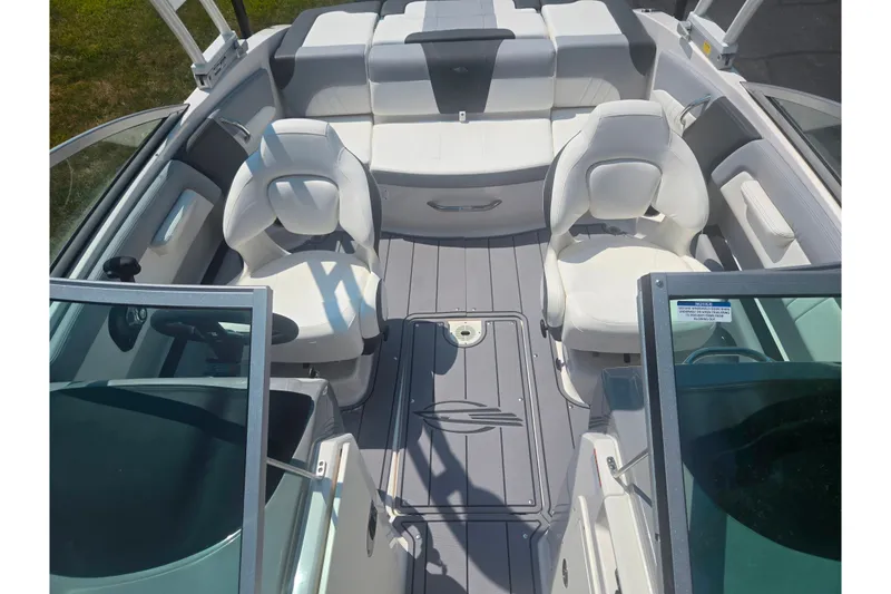 Slide: The Image of 2023 Chaparral 21 SSi boat interior with white seating and sleek design. - 23