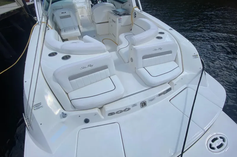 Slide: The Image of 2010 Sea Ray 300 SLX boat with white seating and sleek design on the water. - 3