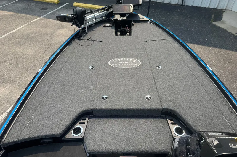 Slide: The Image of 2022 Nitro Z20 boat deck with carpeted surface and fishing equipment. - 6