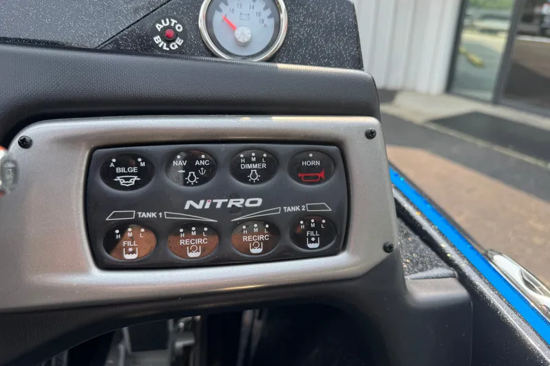 Slide: The Image of Control panel of a 2022 Nitro Z20 boat with various switches and gauges. - 14